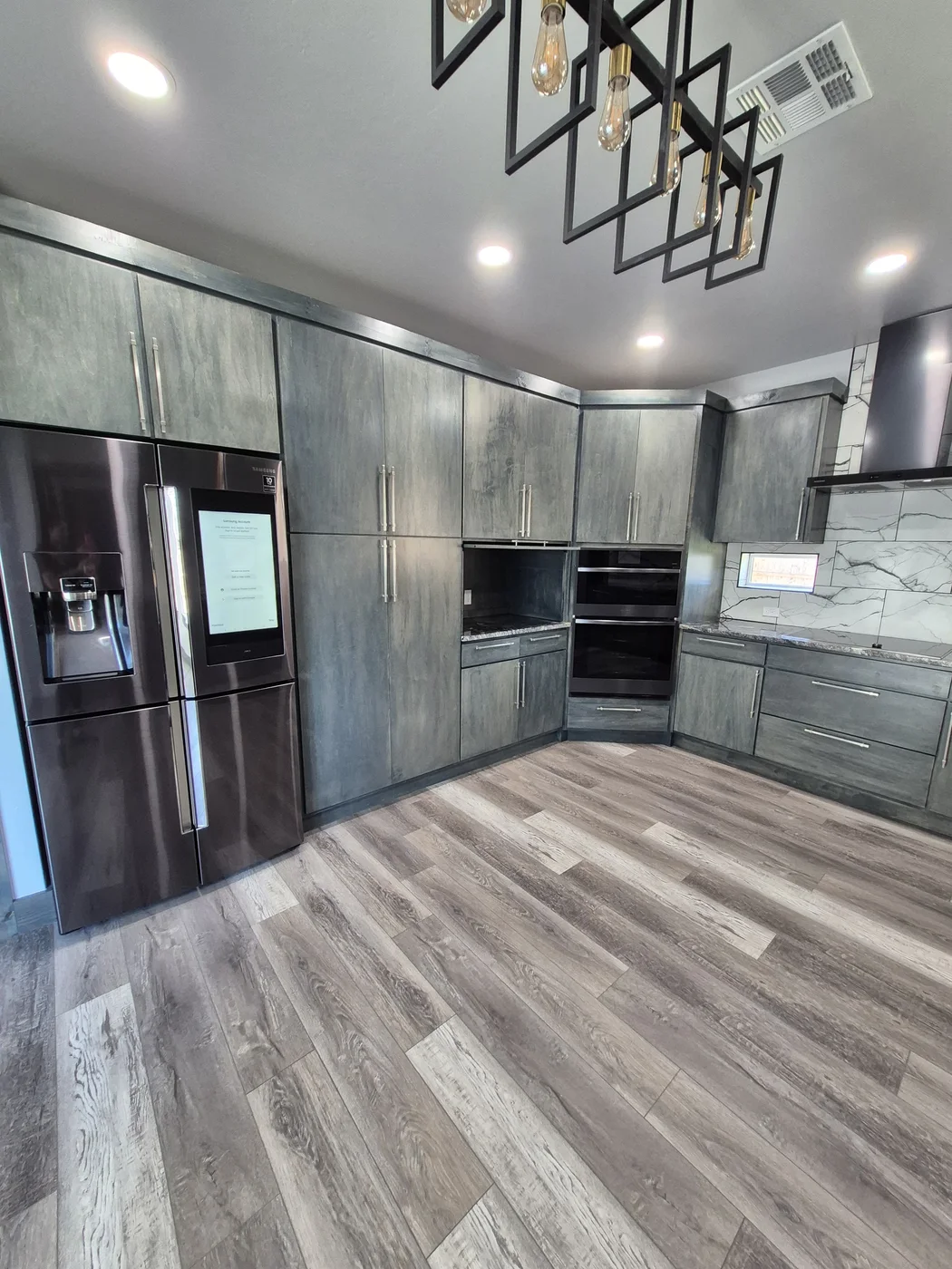 Clean kitchen with dark cabinetry after a deep clean